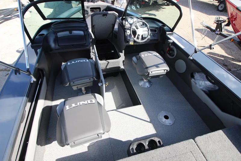 Slide: The Image of 2024 Lund 1775 Crossover XS boat interior with seating and steering console. - 6