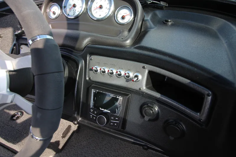 Slide: The Image of 2024 Lund 1775 Crossover XS dashboard with gauges and controls. - 8