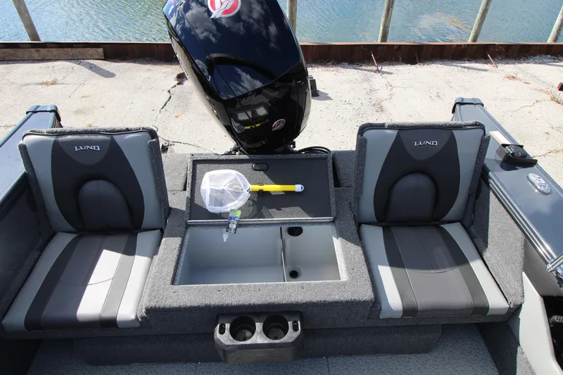Slide: The Image of 2024 Lund 1775 Crossover XS boat interior with seating and storage compartments. - 9