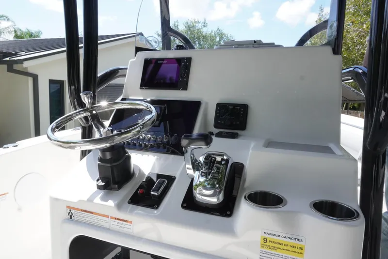 Slide: The Image of 2021 Sea Pro 219 boat console with steering wheel and navigation controls. - 10