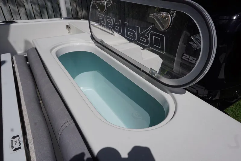 Slide: The Image of 2021 Sea Pro 219 boat livewell with open lid, showcasing interior design. - 20