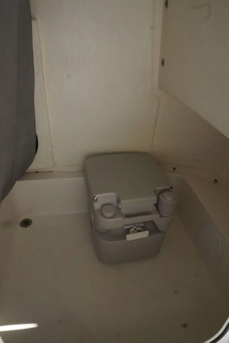 Slide: The Image of 2021 Sea Pro 219 boat interior with portable toilet. - 21