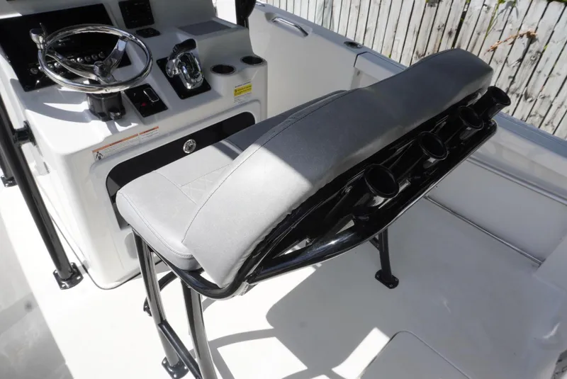 Slide: The Image of 2021 Sea Pro 219 boat interior with steering console and cushioned seating. - 22