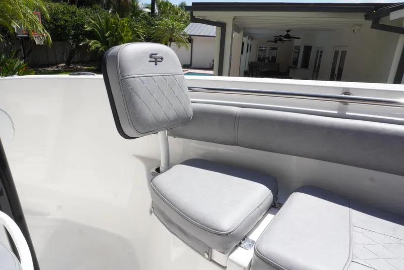Slide: The Image of 2021 Sea Pro 219 boat with gray seating and backrest in a sunny outdoor setting. - 26