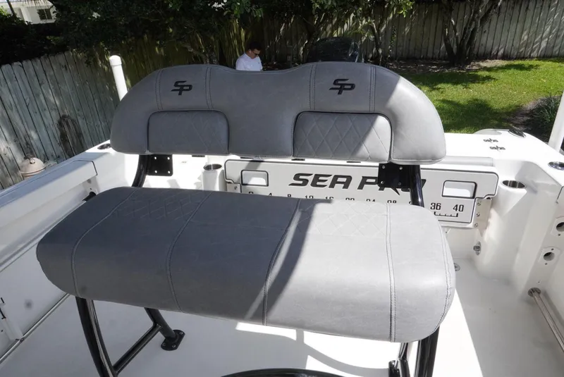 Slide: The Image of 2021 Sea Pro 219 boat seating with gray upholstery and logo detail. - 28