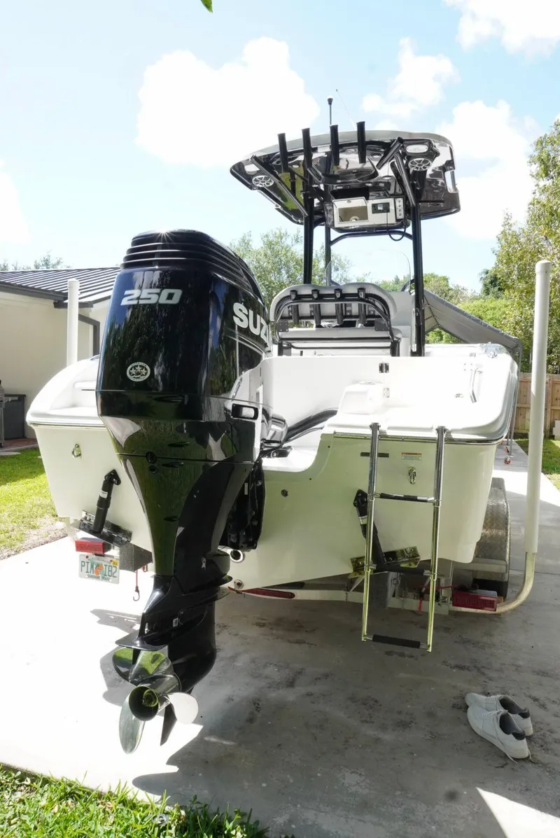 Slide: The Image of 2021 Sea Pro 219 boat with Suzuki 250 outboard motor, parked outdoors. - 4