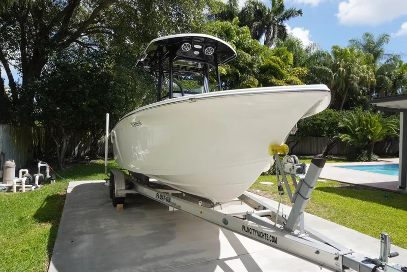 Slide: The Image of 2021 Sea Pro 219 boat on trailer in sunny backyard setting. - 5