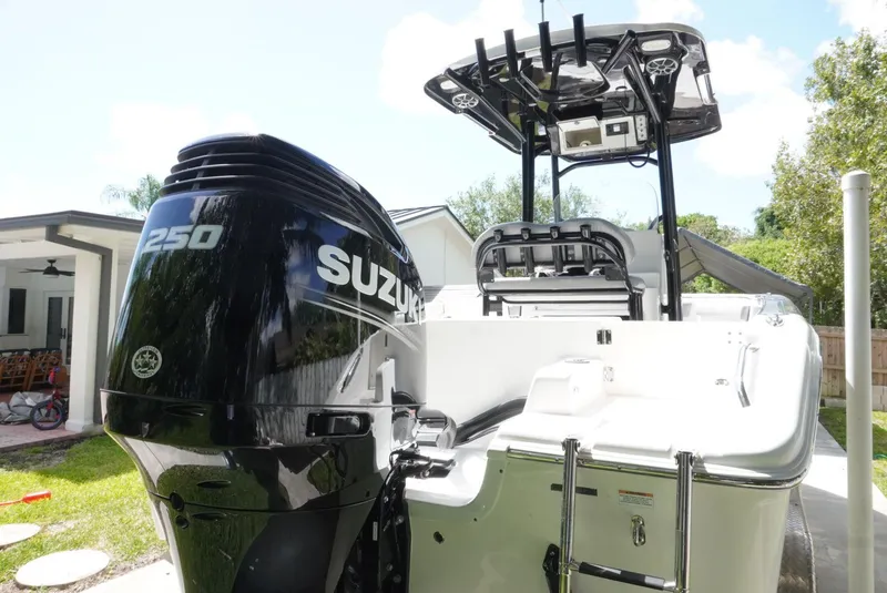 Slide: The Image of 2021 Sea Pro 219 boat with Suzuki 250 outboard motor, parked outdoors. - 7