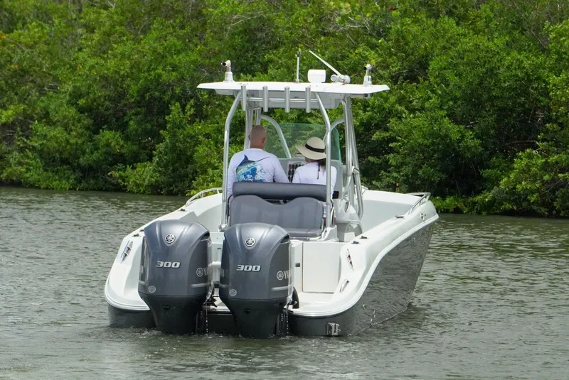 Slide: The Image of 2004 Baja 340 Sportfish boat with dual engines cruising on a river. - 10
