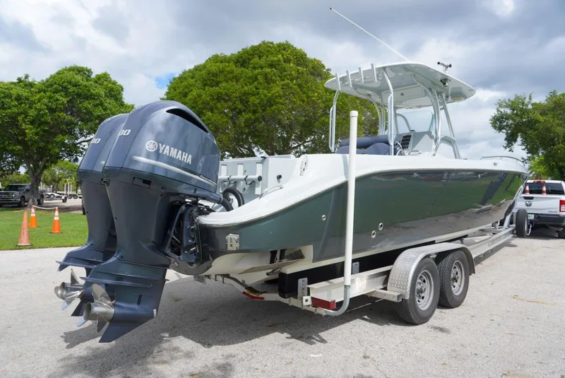Slide: The Image of 2004 Baja 340 Sportfish boat on trailer with Yamaha outboard motor, parked outdoors. - 24