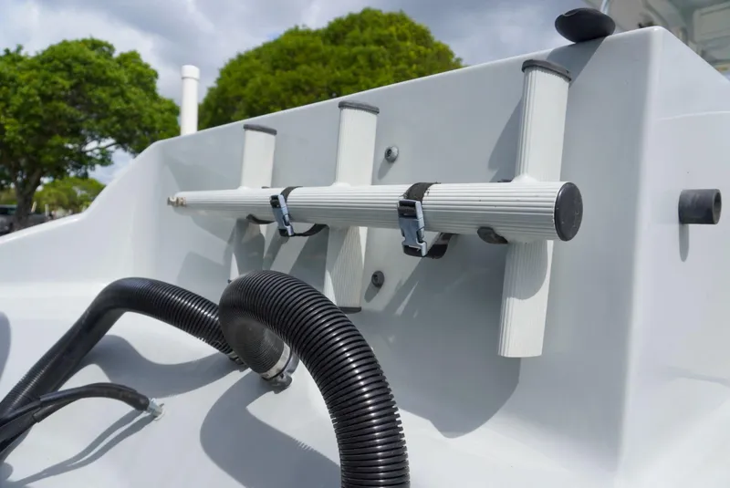 Slide: The Image of Rod holders on a 2004 Baja 340 Sportfish boat, with hoses and trees in the background. - 26
