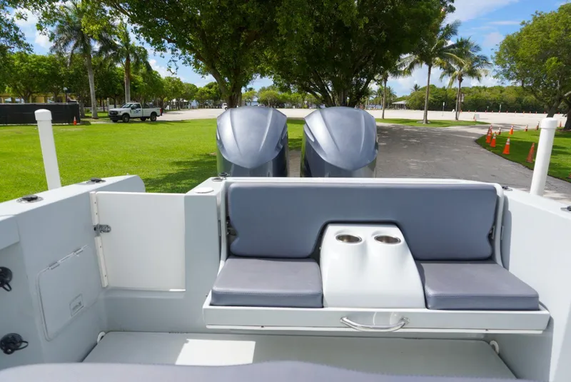 Slide: The Image of 2004 Baja 340 Sportfish boat interior with dual engines and cushioned seating. - 27