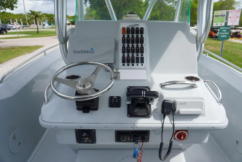 Slide: The Image of 2004 Baja 340 Sportfish helm with Garmin navigation, steering wheel, and control panel. - 28