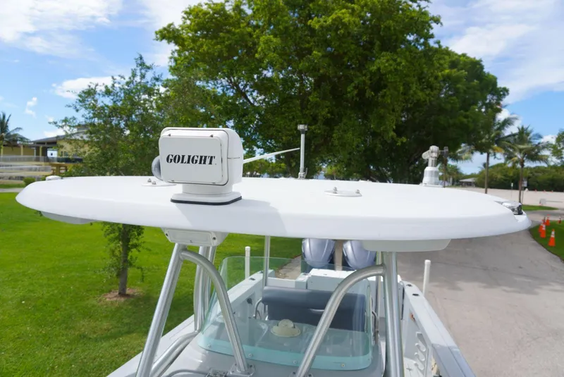 Slide: The Image of 2004 Baja 340 Sportfish boat with Golight spotlight on top, surrounded by greenery. - 35