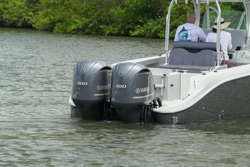 Slide: The Image of 2004 Baja 340 Sportfish with twin Yamaha 300 engines on a calm waterway. - 9