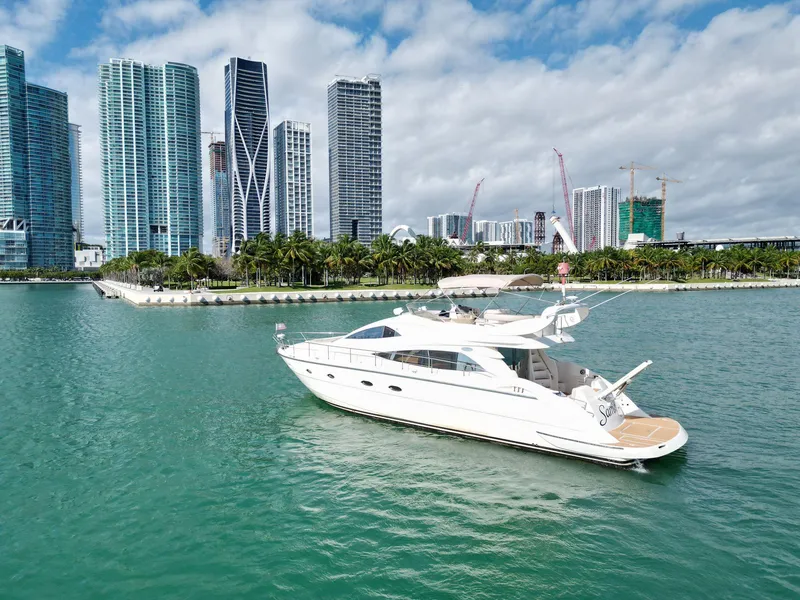 Slide: The Image of Luxury Aicon 56 yacht cruising near city skyline, 2003 model. - 11