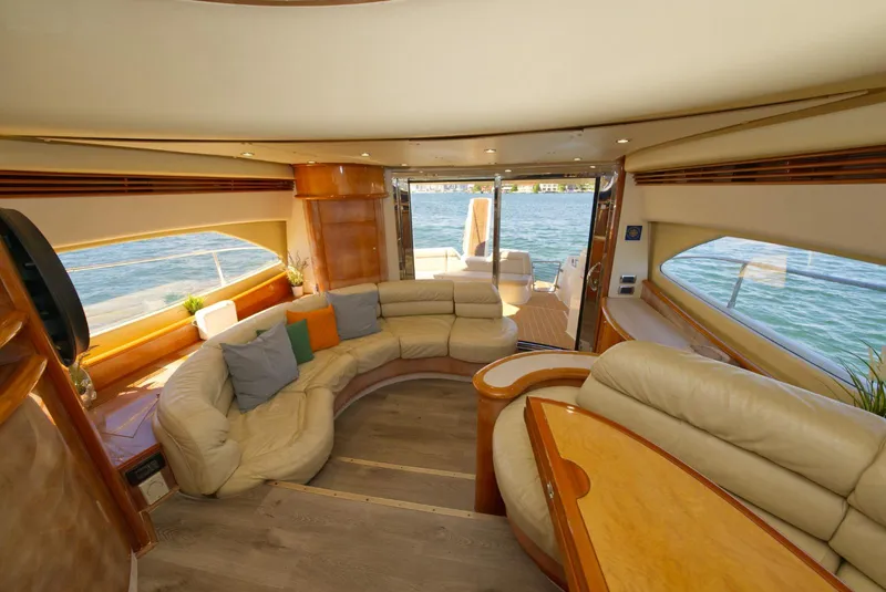 Slide: The Image of Luxurious interior of 2003 Aicon 56 yacht with plush seating and panoramic windows. - 16