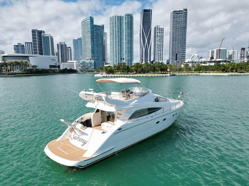 Slide: The Image of Luxury Aicon 56 yacht cruising near city skyline, 2003 model. - 17