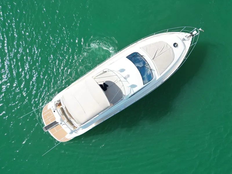 Slide: The Image of Aerial view of 2003 Aicon 56 yacht on turquoise water. - 18