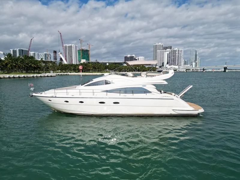 Slide: The Image of Aicon 56 yacht from 2003 cruising near a city skyline. - 2