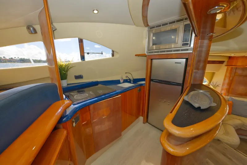 Slide: The Image of Luxurious 2003 Aicon 56 yacht kitchen with modern appliances and sleek wood finishes. - 20