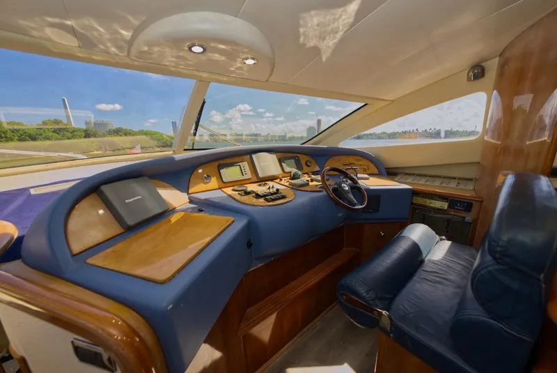 Slide: The Image of Luxurious 2003 Aicon 56 yacht interior with modern navigation controls and plush seating. - 25