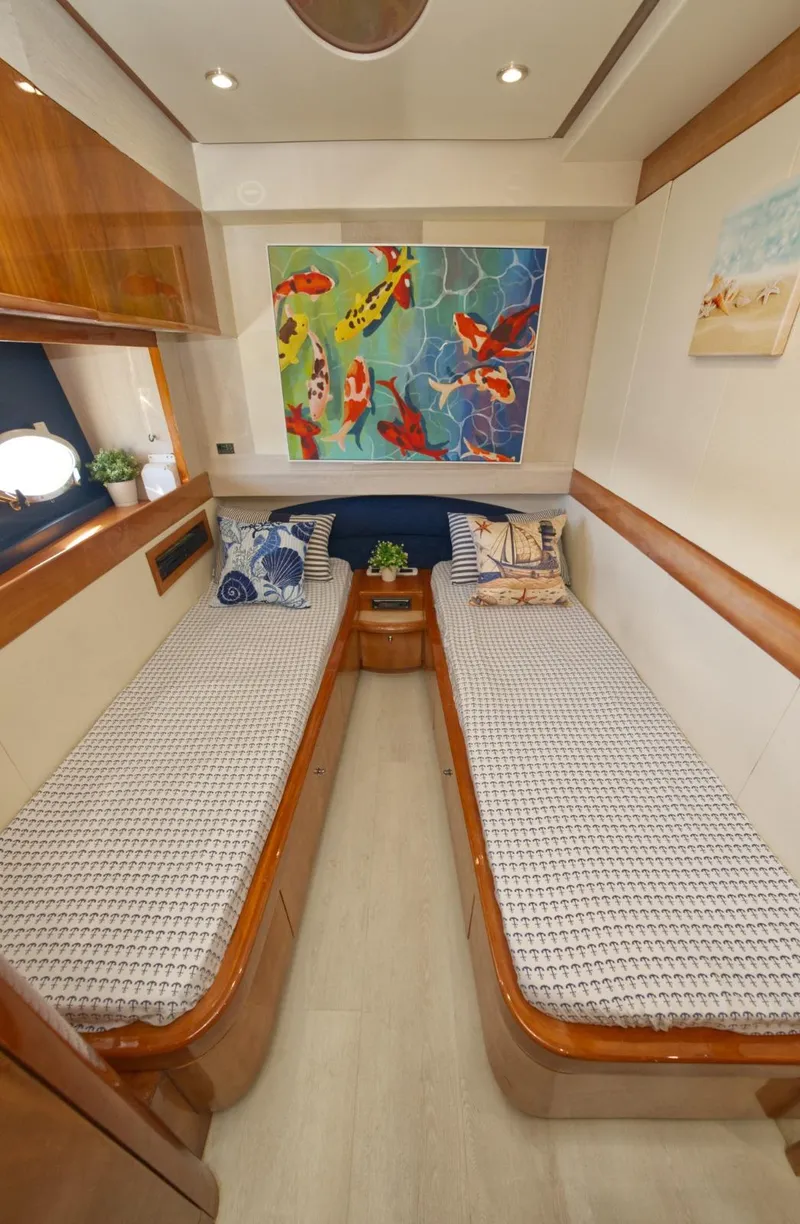 Slide: The Image of Luxurious 2003 Aicon 56 yacht cabin with twin beds and vibrant artwork. - 27