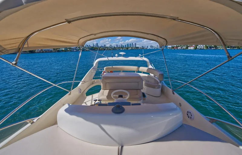 Slide: The Image of Aicon 56 yacht, 2003 model, cruising on blue waters with city skyline in background. - 36