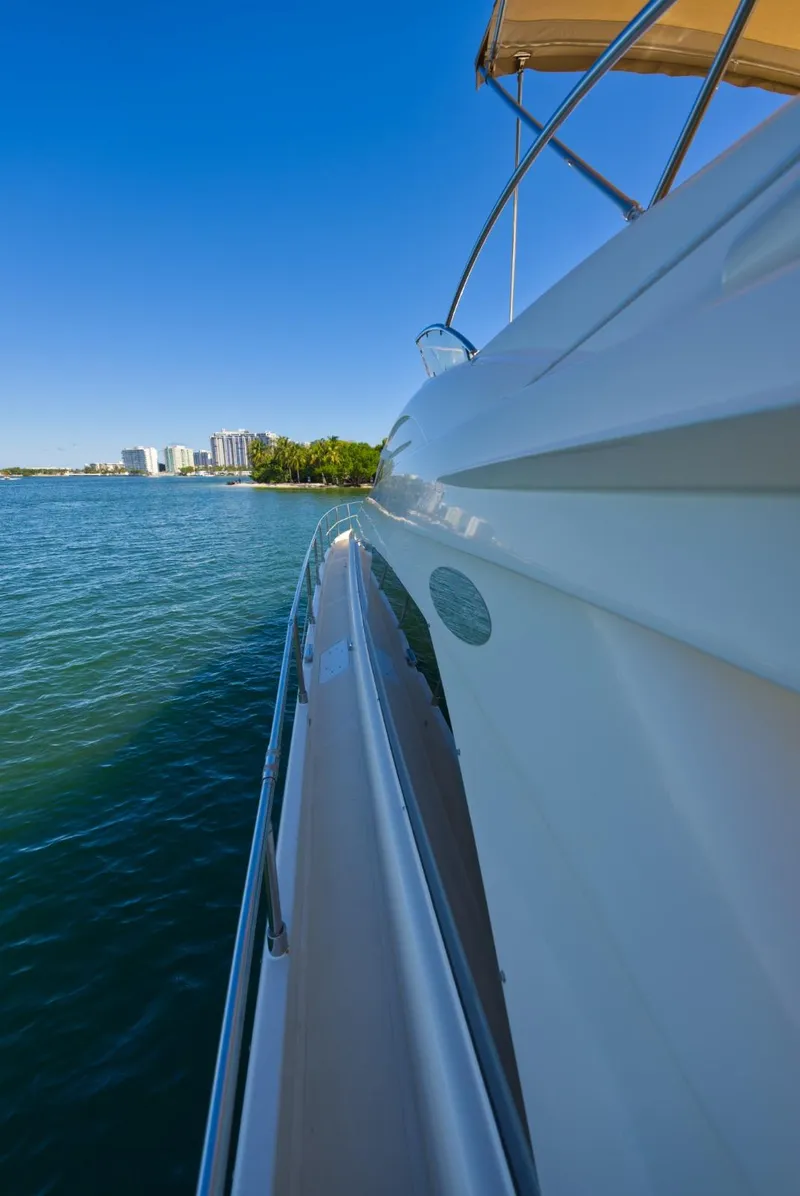 Slide: The Image of Side view of 2003 Aicon 56 yacht on calm water with city skyline. - 39