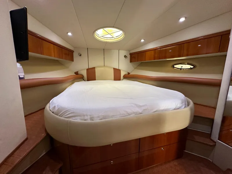 Slide: The Image of Luxurious cabin interior of 2001 Sunseeker 44 Camargue yacht with cozy bed and elegant wood finish. - 12