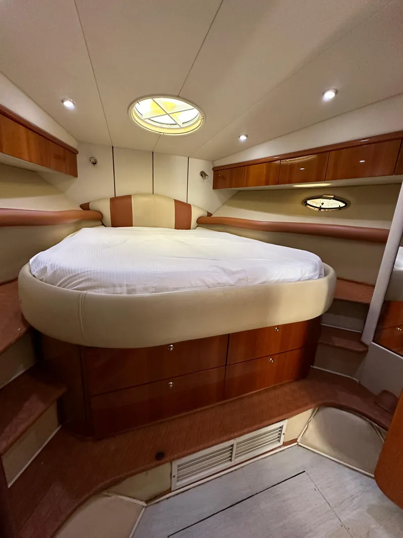 Slide: The Image of Luxurious cabin interior of 2001 Sunseeker 44 Camargue yacht with cozy bed and wood accents. - 13