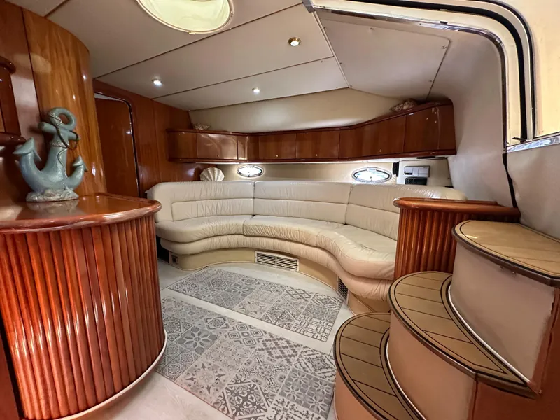 Slide: The Image of Luxurious interior of 2001 Sunseeker 44 Camargue yacht with elegant seating and wood finishes. - 16