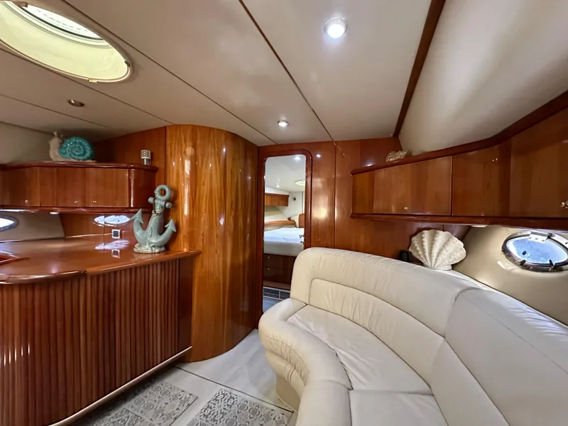 Slide: The Image of Luxurious interior of 2001 Sunseeker 44 Camargue yacht with elegant wood finish and plush seating. - 17