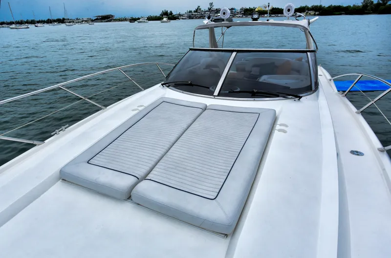 Slide: The Image of 2001 Sunseeker 44 Camargue yacht on water, featuring spacious deck and sleek design. - 2