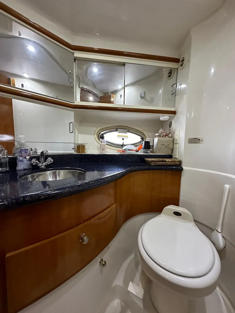 Slide: The Image of Luxurious bathroom in 2001 Sunseeker 44 Camargue yacht with modern fixtures and wood accents. - 21