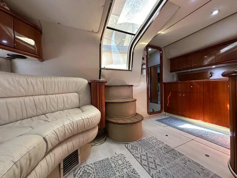 Slide: The Image of Luxurious interior of 2001 Sunseeker 44 Camargue yacht with leather seating and wooden cabinetry. - 25