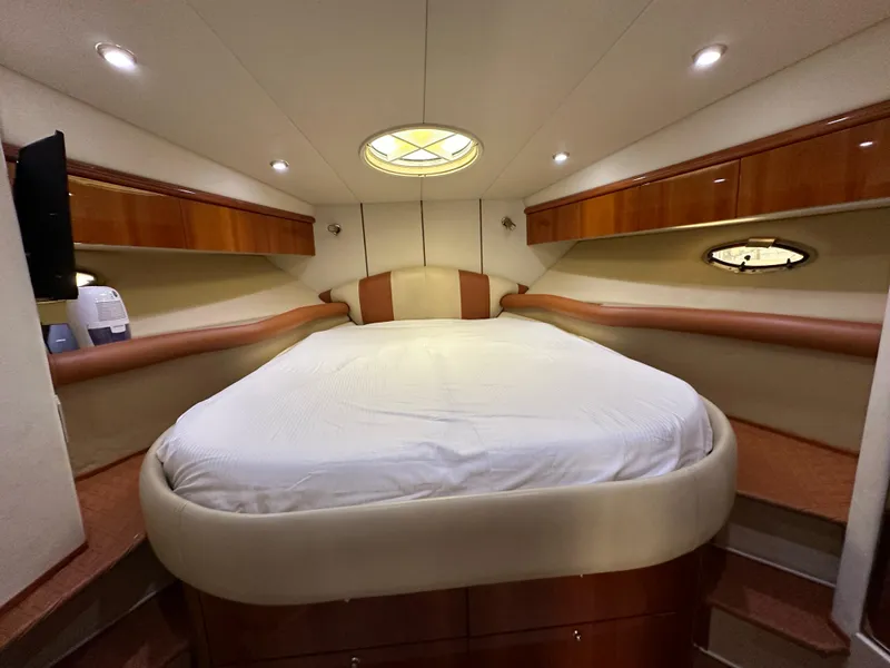 Slide: The Image of Luxurious cabin interior of 2001 Sunseeker 44 Camargue yacht with cozy bed and elegant wood finish. - 26