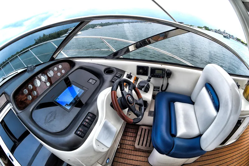 Slide: The Image of Sunseeker 44 Camargue 2001 yacht helm with modern controls and panoramic water view. - 4
