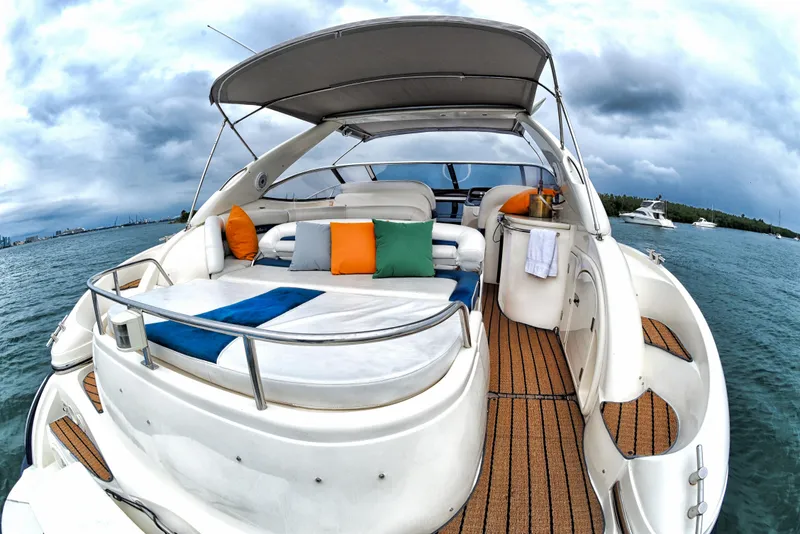 Slide: The Image of Sunseeker 44 Camargue 2001 yacht with spacious deck and colorful cushions on the water. - 5
