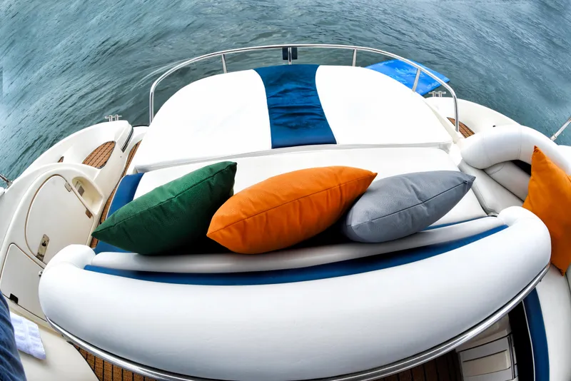 Slide: The Image of Sunseeker 44 Camargue 2001 yacht with colorful cushions on deck, ocean view. - 6
