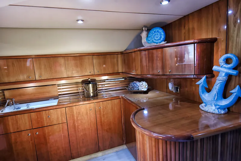 Slide: The Image of Luxurious wooden interior of 2001 Sunseeker 44 Camargue yacht kitchen with nautical decor. - 9