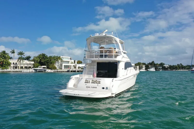 Slide: The Image of 2001 Sea Ray 480 Sedan Bridge yacht cruising in sunny waters. - 11