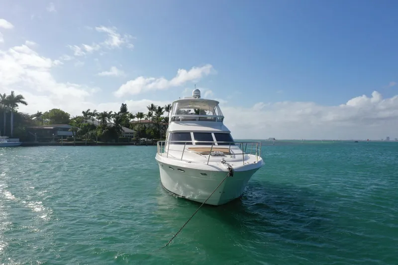Slide: The Image of 2001 Sea Ray 480 Sedan Bridge yacht on clear blue water. - 13