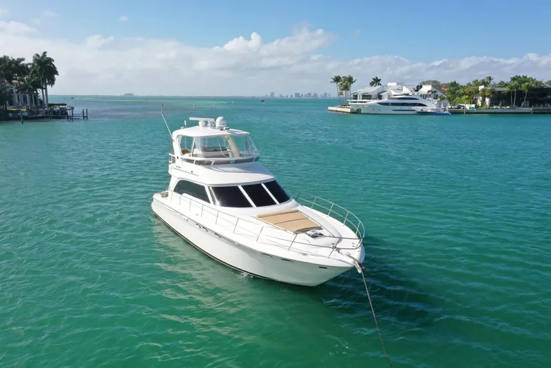 Slide: The Image of 2001 Sea Ray 480 Sedan Bridge yacht on turquoise water, sunny day. - 14