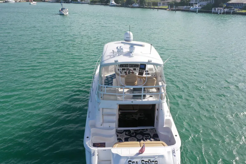 Slide: The Image of 2001 Sea Ray 480 Sedan Bridge yacht on turquoise water, rear view. - 18