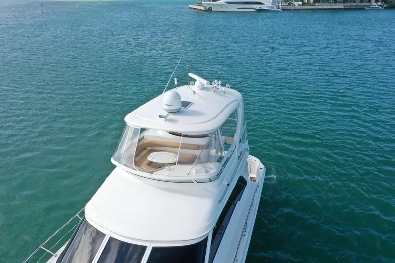 Slide: The Image of 2001 Sea Ray 480 Sedan Bridge yacht on calm blue water. - 19