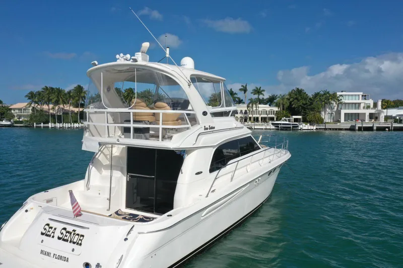 Slide: The Image of 2001 Sea Ray 480 Sedan Bridge yacht on clear blue water. - 20