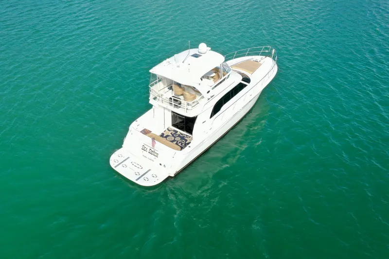 Slide: The Image of 2001 Sea Ray 480 Sedan Bridge yacht on clear turquoise water. - 24
