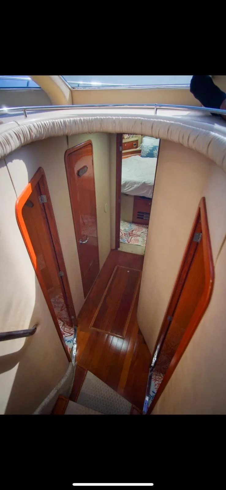 Slide: The Image of Interior hallway of 2001 Sea Ray 480 Sedan Bridge yacht with wooden doors. - 32