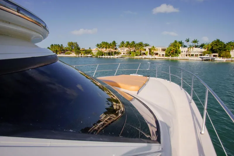 Slide: The Image of 2001 Sea Ray 480 Sedan Bridge yacht cruising near waterfront homes. - 36